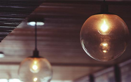 What Causes a Light Bulb to Glow Dimly When the Switch Is Off